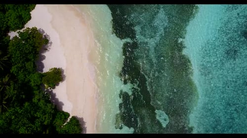 Aerial above nature of paradise lagoon beach break by shallow sea with bright sandy background of a
