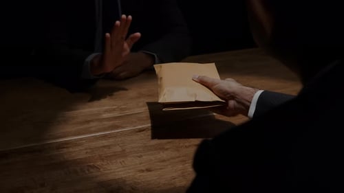 Businessman refusing money in the envelope