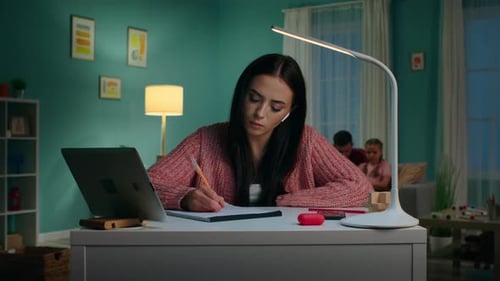 Young Woman Studying at Desk at Home