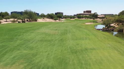 A drone glides above a luxury golf course green.