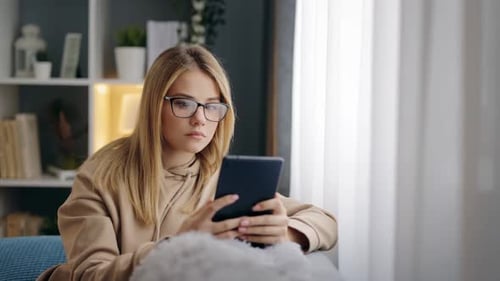 Young Woman Using Tablet at Home