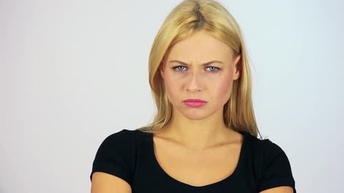 A Young Attractive Woman Shakes Her Head Angrily at the Camera - Face Closeup - White Screen Studio