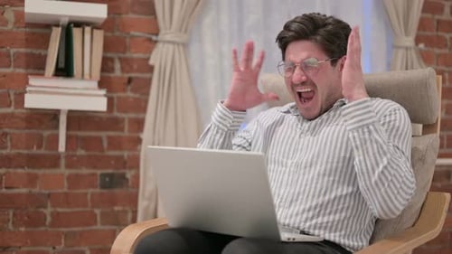 Man Using Laptop Expressing Frustration then Celebrating Success