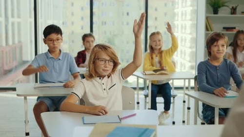 Enthusiastic Students Raising Hands in Classroom