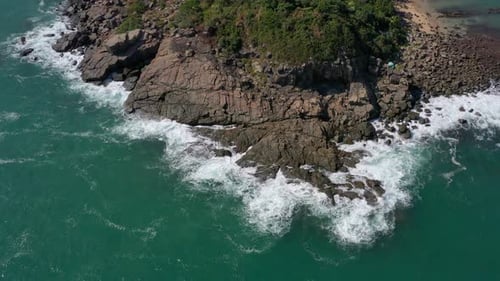 Drone fly over ocean water and rocky cliffs
