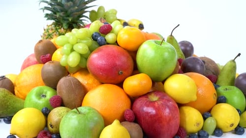 Pile of Colorful Fresh Fruits on White Background