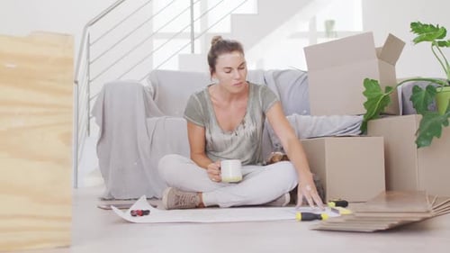 Woman Plans Home Renovation with Coffee