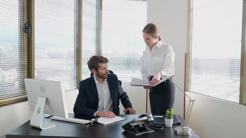 Man and Woman Working in an Office