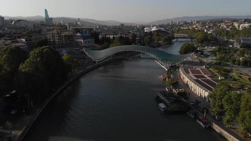 Aerial Shooting of the City Center of Tbilisi in Georgia. Peace Bridge. The Camera Flies To the