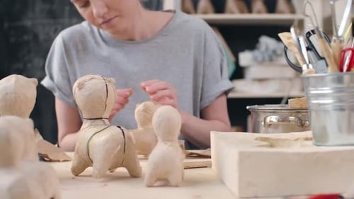 Woman Crafting Plaster Animal Sculptures in Art Studio