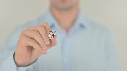 Hand Writes the Words Safety First on Glass