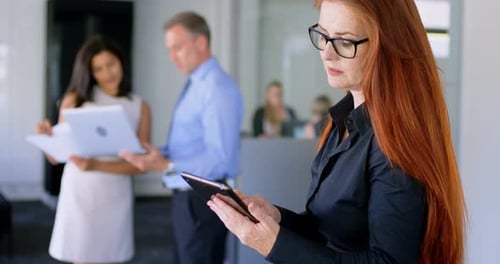 Businesswoman Using Tablet in a Modern Office