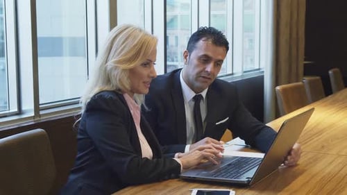 Business Colleagues Working Together on a Laptop in Office