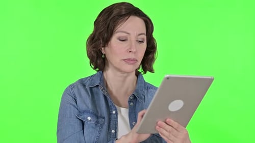 Old Woman Using Digital Tablet on Green Chroma Key Background