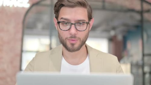 Close Up of Man Talking on Video Call on Laptop