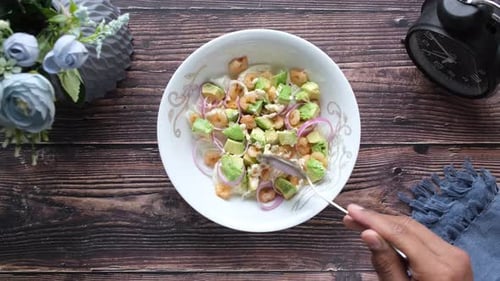 Young Women Eating Avocado Salad