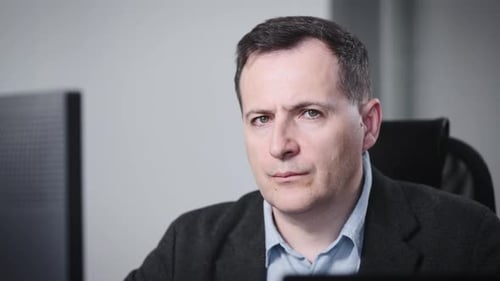 Man in Office Looking Directly at Camera