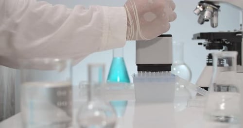 Scientist using Multi Pipette in Laboratory Experiment
