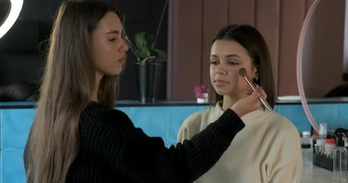 Makeup Artist Applies Makeup to Young Woman