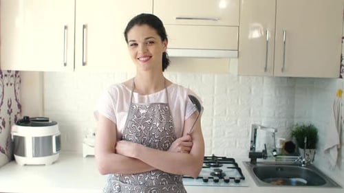 Woman Smiling in Kitchen Ready to Cook
