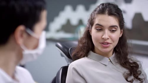 Female Dentist Talking to Patient