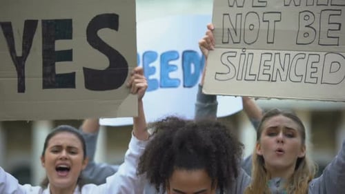 Group of Young Adults Protesting With Signs
