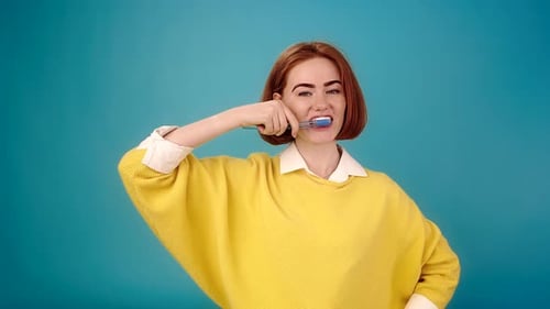 Woman Brushing Teeth with Toothbrush