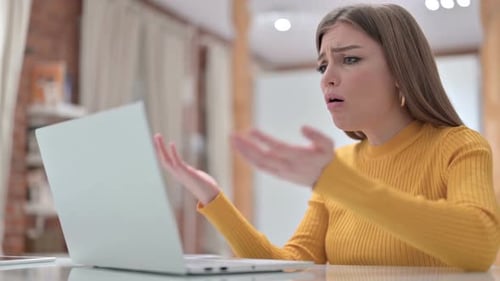 Woman Looks Upset While Working on Laptop