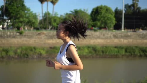 Young beautiful asian woman Jogging in the park