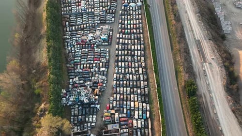 Aerial View of Big Parking Lot of Junkyard with Rows of Discarded Broken Cars