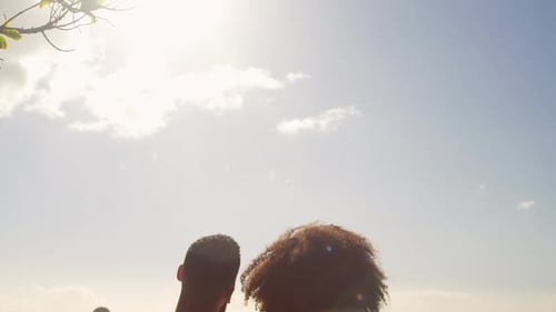 Couple sitting together on a bench in the beach 4k