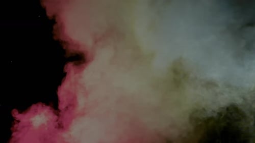 Colorful Powder Cloud Expanding on Black Background