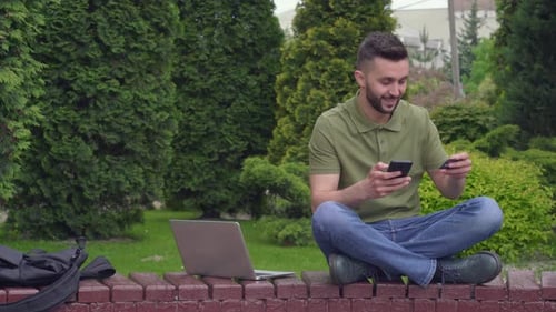 Happy Bearded Man Buying Goods in Online Store By Cell Phone
