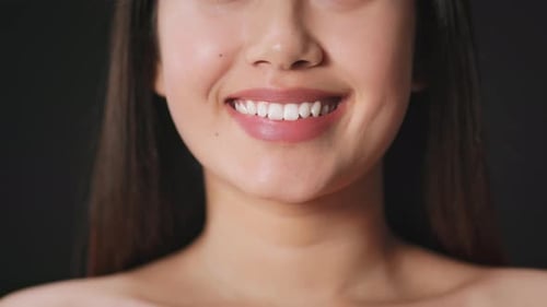 Woman's Mouth Smiles Showing Teeth, Close Up