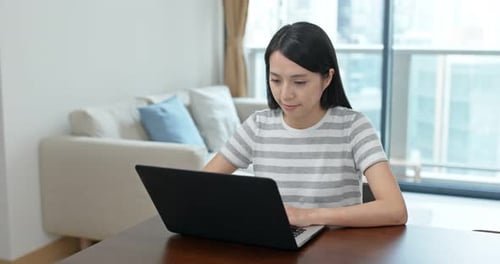 Woman Working on Laptop Computer at Home