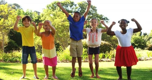 Group of kids jumping together in park