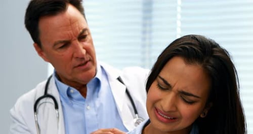 Doctor Examining Woman's Neck in Bright Office