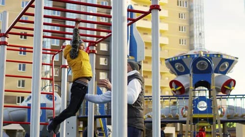 Caucasian Kid Playing on Monkey Bars in Playground