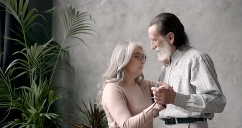 Loving Senior Couple Slow Dancing in their Home