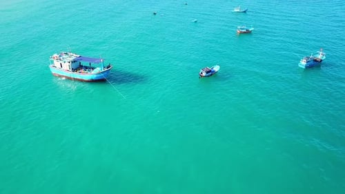 Aerial Footage of Different Multicoloured Fishing Boats in Blue Ocean Water