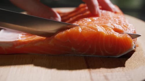 Cutting Fish on Slices for Cooking Sushi in Slow Motion