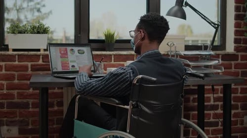 Man with Special Needs Working on Commercial Report During Pandemic