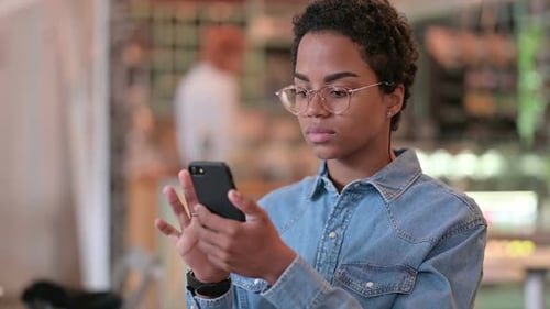 Woman Uses Smartphone in Urban Setting