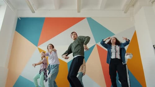 Portrait of People Hipsters Dancing in Hip-hop Studio Moving To Music Indoors