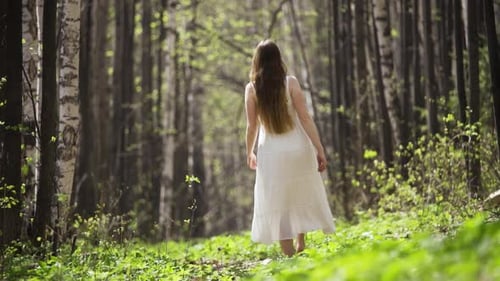 Woman Walking Barefoot Through a Beautiful Forest