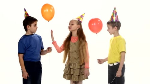 Children Celebrate With Balloons and Party Hats