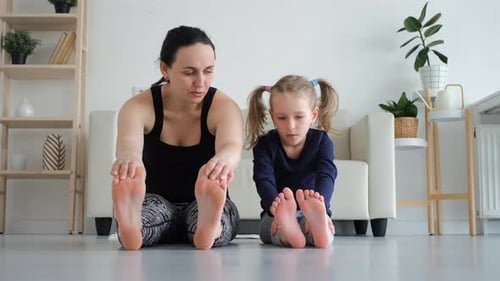 Woman with Daughter Doing Stretching Exercises