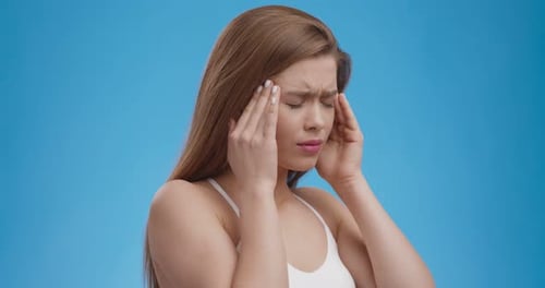 Acute Headache. Temples, Suffering From Migraine Attack, Blue Studio Background