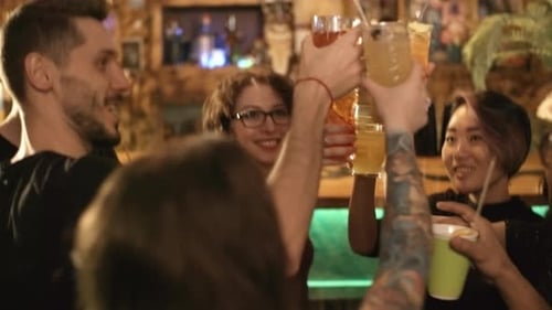 Friends Toasting Drinks at a Lively Bar