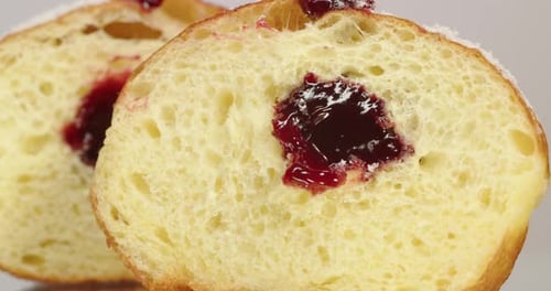 Halved Jelly Donut with Sugary Filling Close-Up
